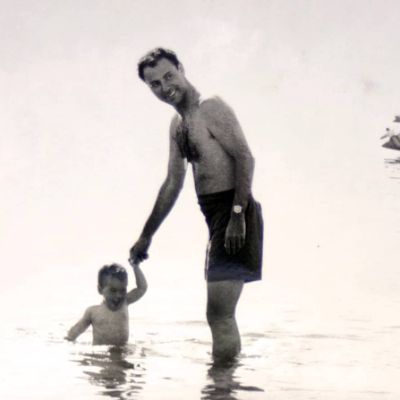 A black and white image of Alan Arkin with his youngest son, Anthony Arkin as a baby .